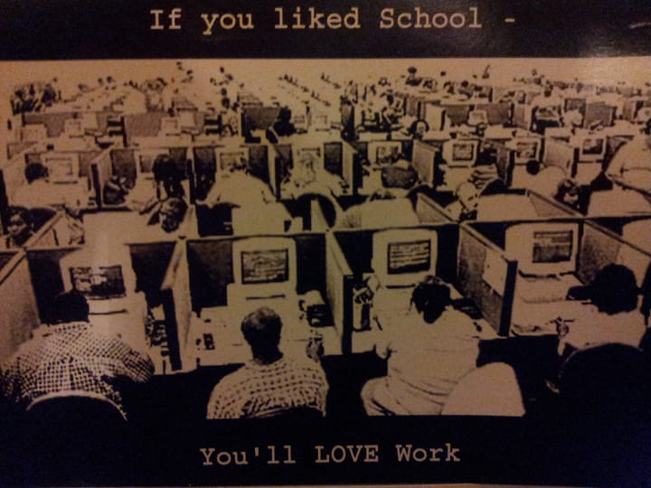 Dozens of people sat at rows upon rows of desks with the caption "If you liked school, you'll love work."